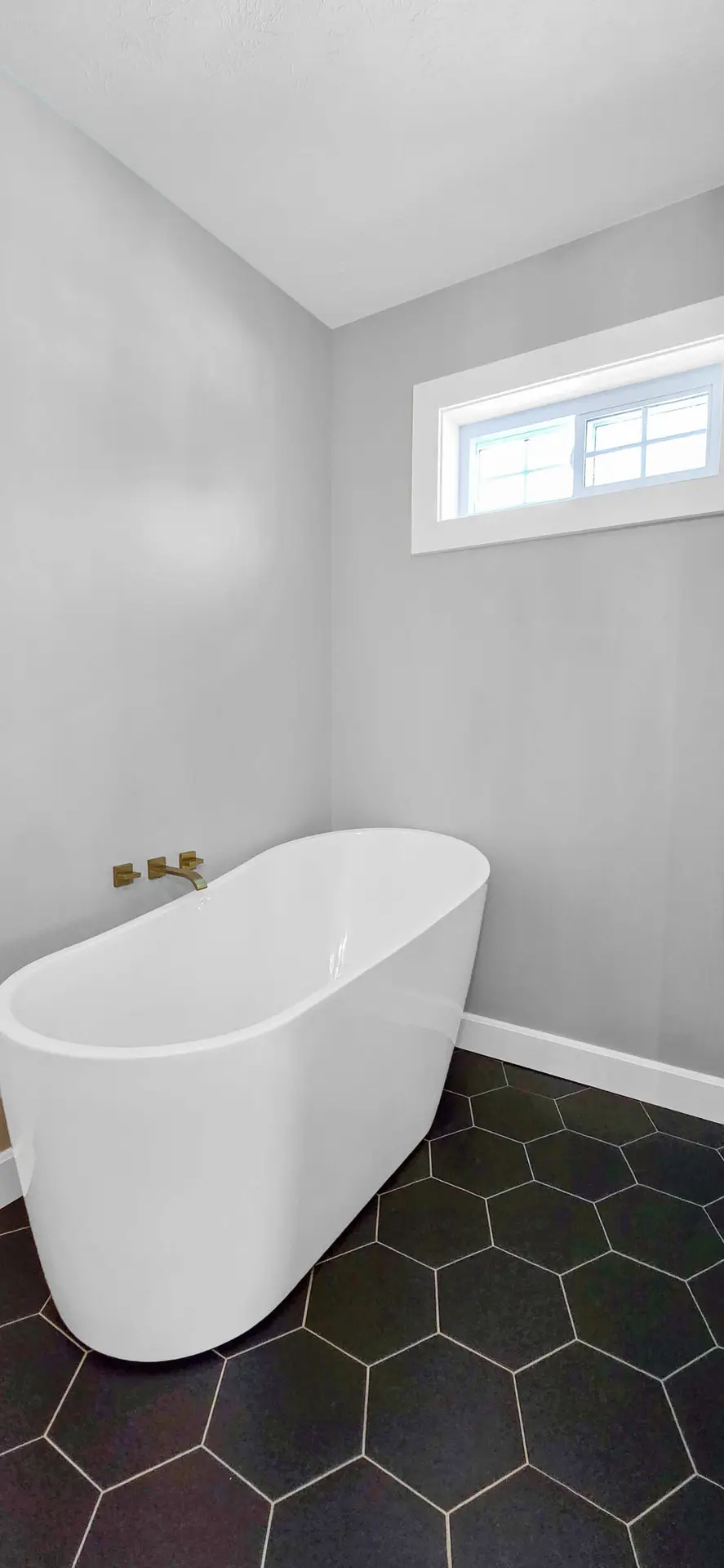 Marble subway tile shower with pebble stone floor