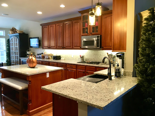 Cherry kitchen with granite island and blue walls